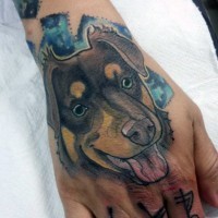 Cartoon like painted and colored little dog portrait on hand