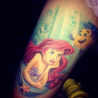 Cartoon mermaid Ariel and Flounder fish at sea bottom multicolored realistic thigh tattoo