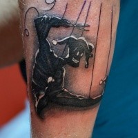 Cartoon style colored arm tattoo of creepy puppet monster