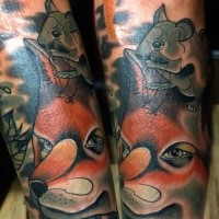 Cartoon style colored arm tattoo of funny fox with mouse