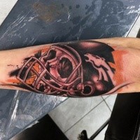 Cartoon style colored arm tattoo of human skull with helmet