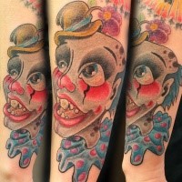 Cartoon style colored arm tattoo of monster clown
