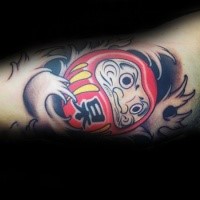 Cartoon style colored biceps tattoo of daruma doll with lettering