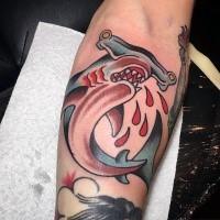 Cartoon style colored bloody hammerhead shark tattoo on forearm