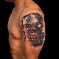 Cartoon style colored evil superhero tattoo on shoulder