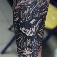 Cartoon style colored forearm tattoo of evil monsters faces