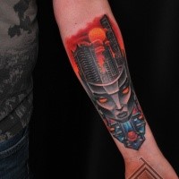 Cartoon style colored forearm tattoo of alien mask with city