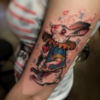 Cartoon style colored funny fantasy bunny tattoo on arm
