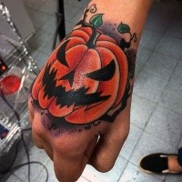 Cartoon style colored hand tattoo of monster pumpkin