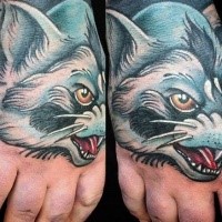 Cartoon style colored hand tattoo of evil wolf and cat face