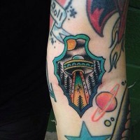 Tatuaje en el antebrazo, arma antigua decorada con nave extraterrestre multicolor