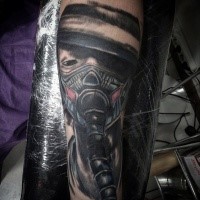 Cartoon style colored mystical man with gas mask tattoo on forearm