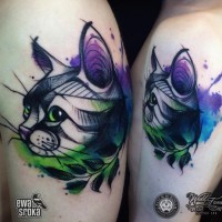 Cartoon style colored shoulder tattoo of cat with leaf