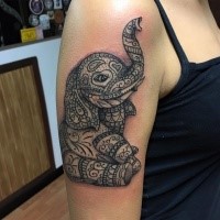 Cartoon style colored shoulder tattoo of funny elephant with ornaments