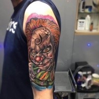 Cartoon style colored shoulder tattoo of maniac clown tattoo on shoulder