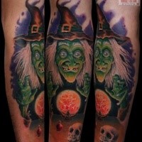 Cartoon style colored tattoo of witch with human skull and magical orb