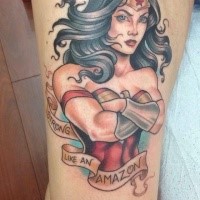 Cartoon style colored thigh tattoo of fantasy Wounder woman and lettering