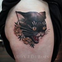 Cartoon style colored thigh tattoo of cat head with flowers