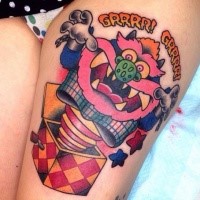 Cartoon style colored thigh tattoo of funny scary toy with lettering