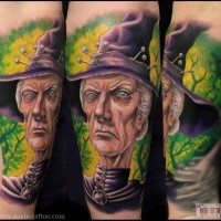 Cartoon style colorful forearm tattoo of evil witch portrait