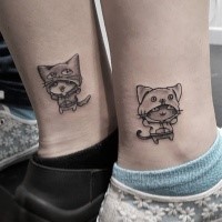 Cartoon style cute looking ankle tattoo of funny cats