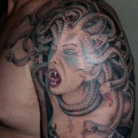 Cartoon style detailed shoulder tattoo of large evil Medusa portrait