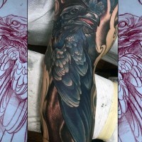 Cartoon style painted and colored big crow tattoo on sleeve