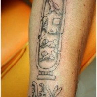 Cartouche and egyptian hieroglyphs tattoo on arm