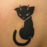 Black cat with small horns tattoo