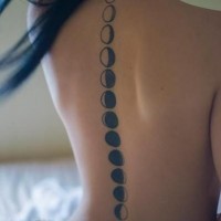 Beautiful black and white tattoo moon phase along the spine