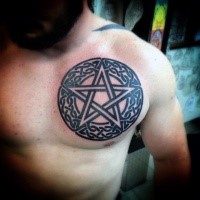 Celtic style black ink chest tattoo of demonic cross and circle
