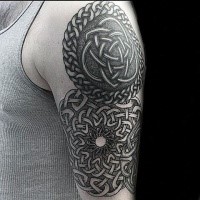 Celtic style black ink shoulder tattoo of various knots