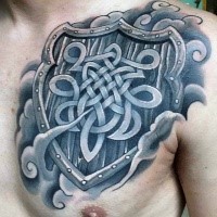 Celtic style colored chest tattoo of big shield with emblem
