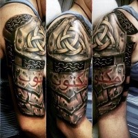 Celtic style colored shoulder tattoo of armor with emblems