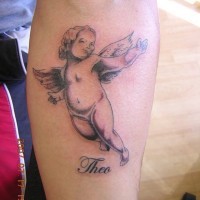 Cherub baby and name tattoo on leg
