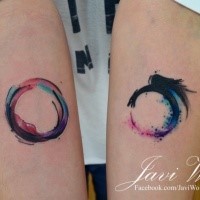 Circle and unfinished circle forearm tattoo by Javi Wolf with colored watercolor details