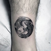 Circle shaped black and white fishes Pisces special symbol tattoo on ankle