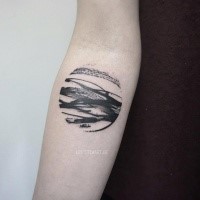 Circle shaped black ink forearm tattoo of sea waves