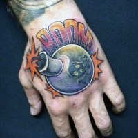 Circle shaped colored hand tattoo of funny bomb and lettering
