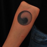 Circle shaped forearm tattoo of Yin Yang shaped symbol