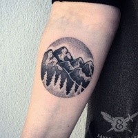 Circle shaped stippling style forearm tattoo of mountains with forest