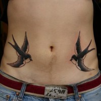 Classic swallow birds tattoo on man's belly