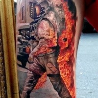 Colored amazing looking arm tattoo of burning astronaut