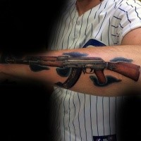 Colored arm tattoo of very detailed AK rifle with clouds