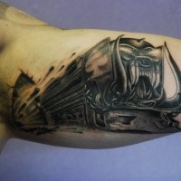 Colored black and gray biceps tattoo of demonic train