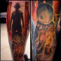 Colored creepy looking leg tattoo of evil doll with Freddy Kruger