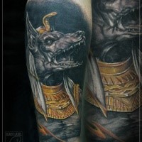 Colored fantasy style forearm tattoo of creepy Egypt God