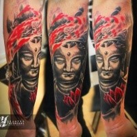 Colored forearm tattoo of Buddha statue