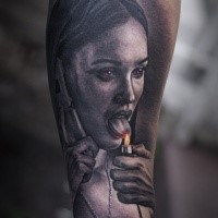 Colored forearm tattoo of creepy woman with lighter