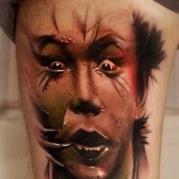 Colored horror style arm tattoo of creepy looking man